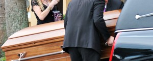 Povsem neprimerno? Žena milijarderja s pijačo v roki fotografirala krsto s pokojno hčerko