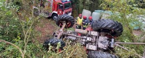 Foto: S traktorjem se je odkotalil po strmem pobočju, ena oseba padla s priključka