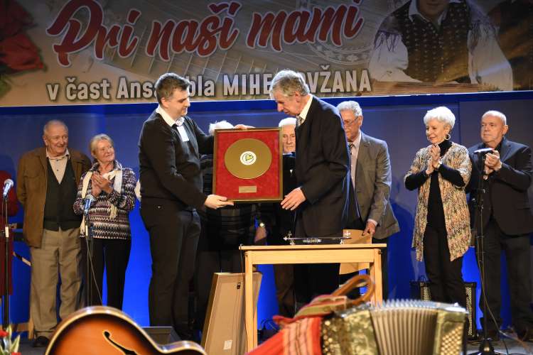 Simon Golobič v imenu Radia Veseljak podeljuje zlato ploščo Mihi Dovžanu.