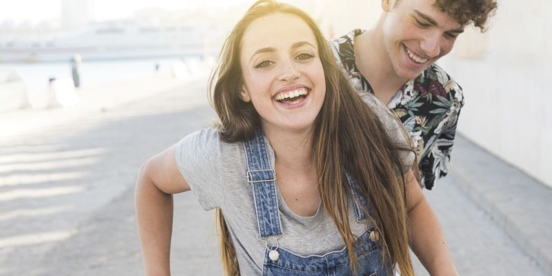 smiling-young-couple-riding-bicycle.jpg