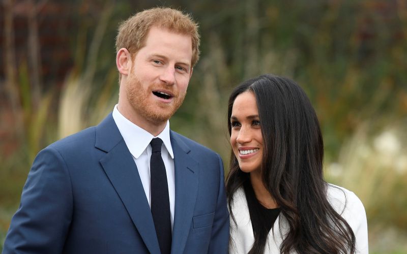 Britain's Prince Harry poses with Meghan Markle in the Sunken Garden of Kensington Palace