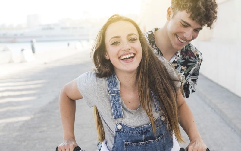 smiling-young-couple-riding-bicycle.jpg