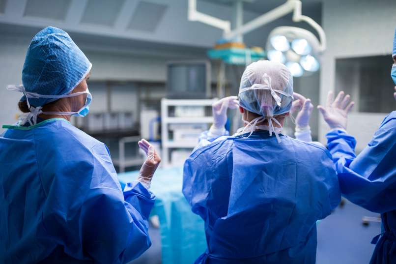 rear-view-surgeons-preparing-operation-operation-room