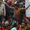 Migrants react, as they wait to cross the border from Greece to Gevgelija
