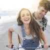 smiling-young-couple-riding-bicycle.jpg