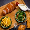kiev-style-cutlet-wooden-board-with-french-fries-arugula-tomato-cucumber-sauce-top-view.jpg