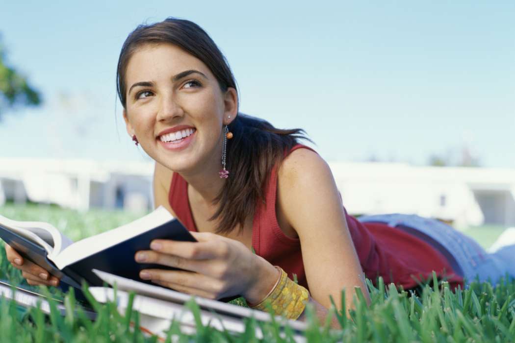 teen_girl_reading_outdoors_57281977