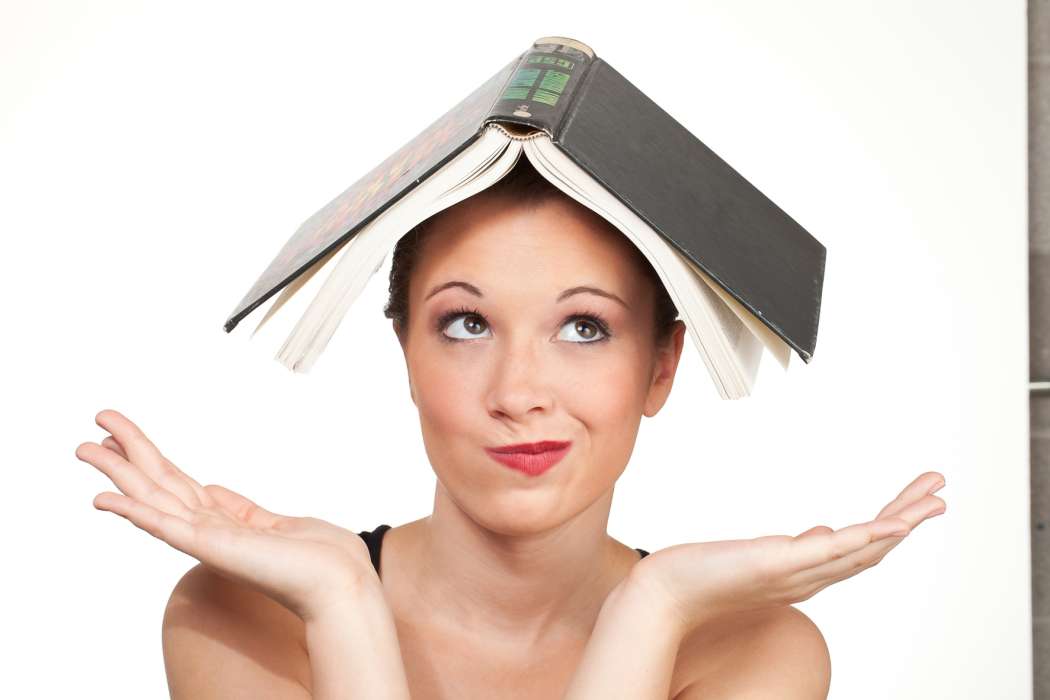 Kozzi-confused-expression-head-shot-with-book-on-head-1774x1183