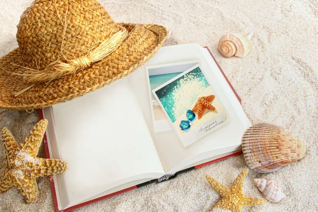 straw_hat_open_book_seashells_starfish_sand_background-1920x1080