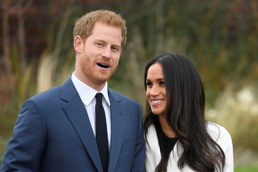 Britain\'s Prince Harry poses with Meghan Markle in the Sunken Garden of Kensington Palace