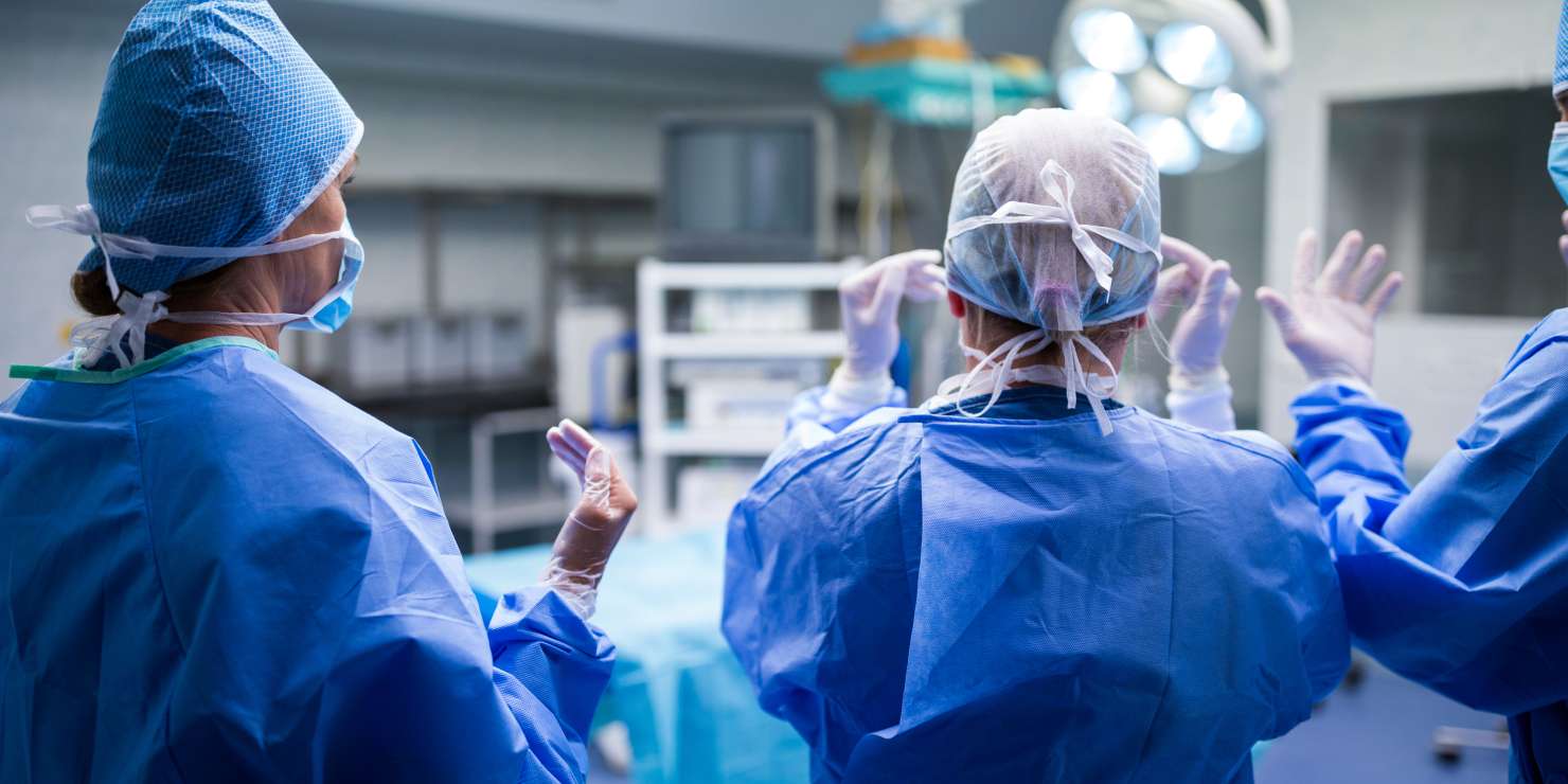 rear-view-surgeons-preparing-operation-operation-room