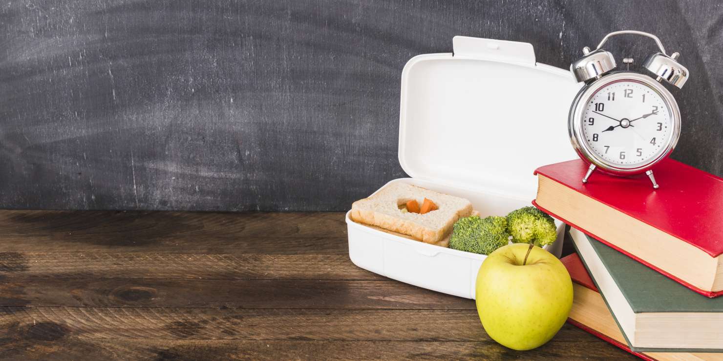 lunchbox-apple-near-books-alarm-clock