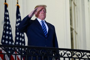 Trump je zapustil bolnišnico in si na balkonu Bele hiše triumfalno snel masko