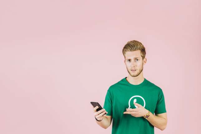 portrait-man-gesturing-while-holding-mobile-phone