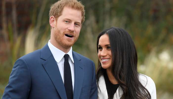 Britain\'s Prince Harry poses with Meghan Markle in the Sunken Garden of Kensington Palace