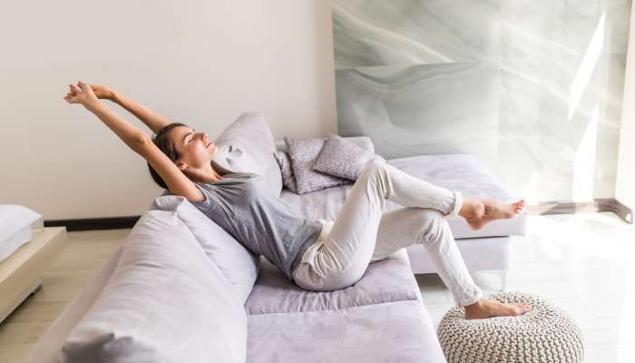 smiling-young-woman-relax-lying-couch