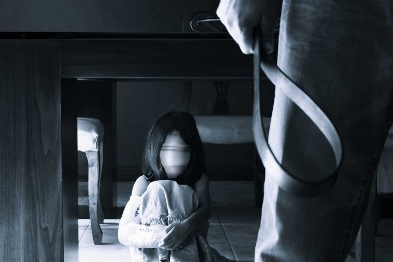 child-hides-under-table-from-man-with-strap-data