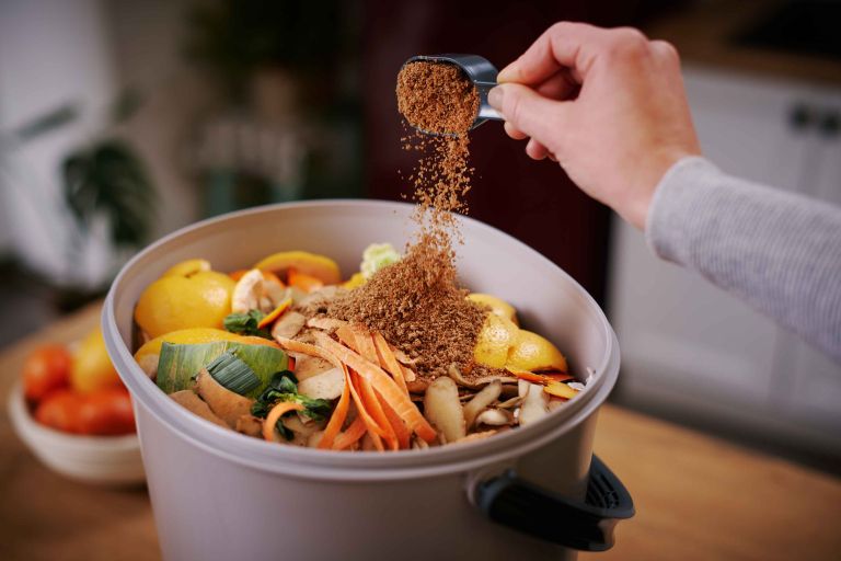 Sprinkling-bokashi-bran-in-Bokashi-Organko-Essential-(2).jpg