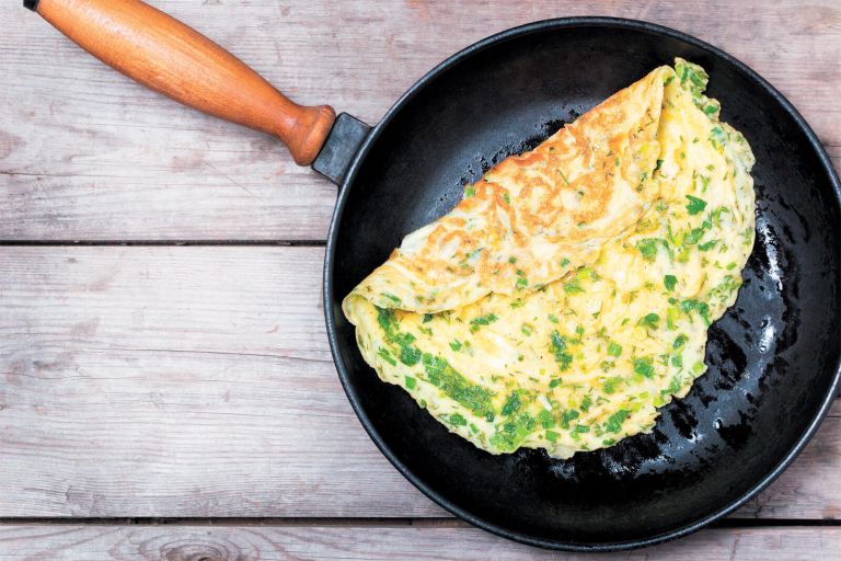 French,Omelet,With,Herbs,,Cooked,In,A,Cast,Iron,Skillet.
