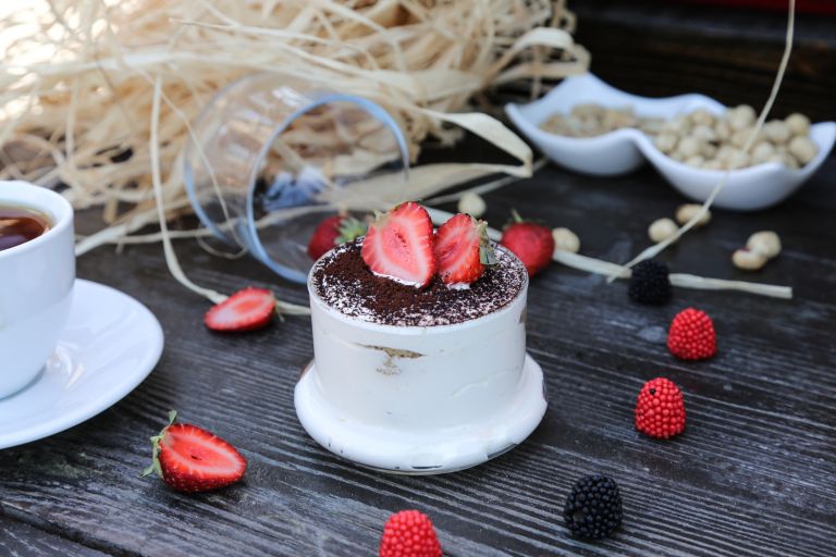 front-view-tiramisu-cup-with-strawberries-table.jpg