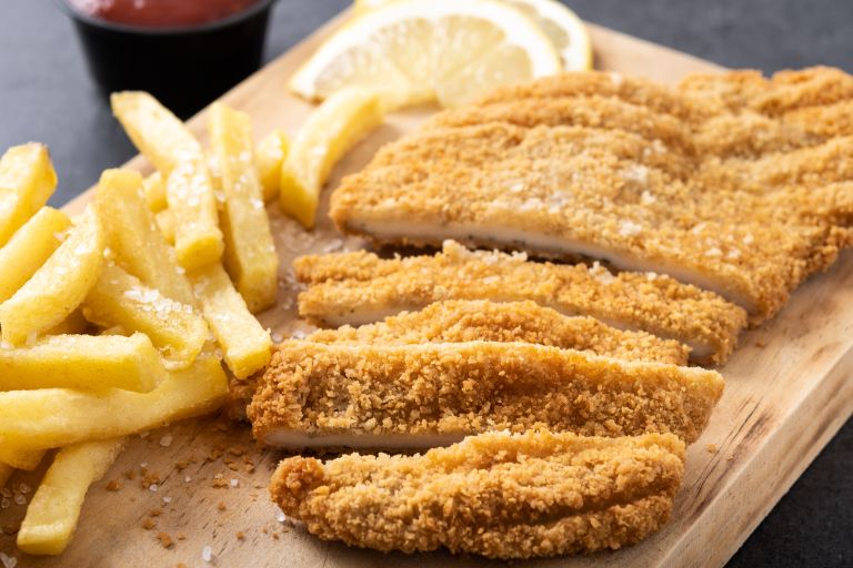 wiener-schnitzel-with-fried-potatoes-black-background.jpg