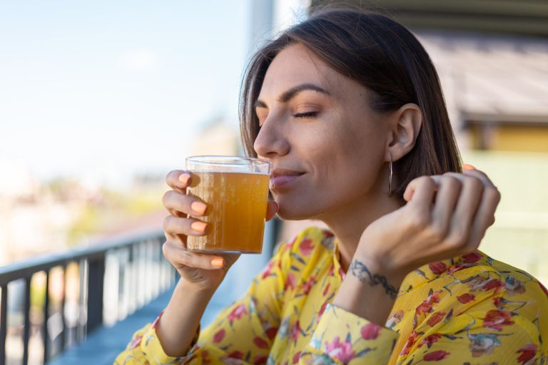 woman-dress-summer-cafe-enjoying-cool-kombucha-glass-beer-sniffing-smell-with-eyes-closed.jpg