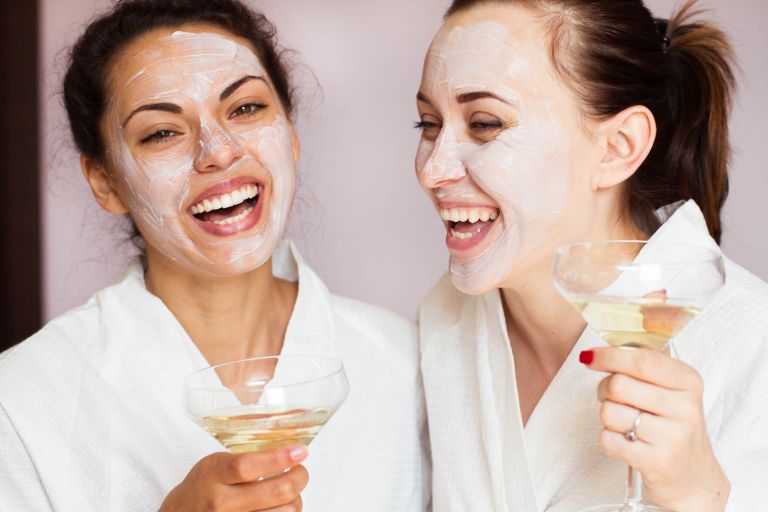 Smiling girlfriends with champagne in the spa salon_shutterstock_567317467.jpg