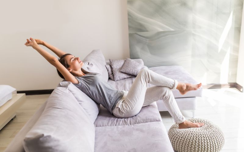 smiling-young-woman-relax-lying-couch.jpg