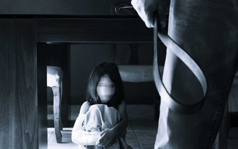 child-hides-under-table-from-man-with-strap-data