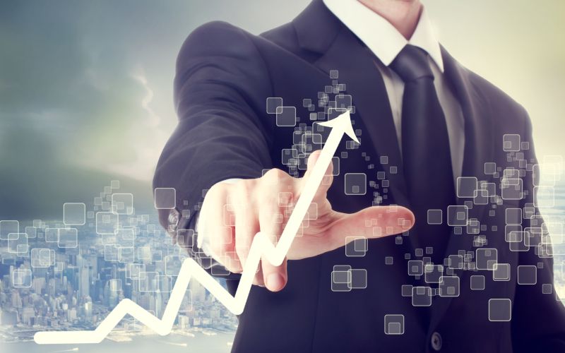 Businessman Touching a Chart Indicating Growth