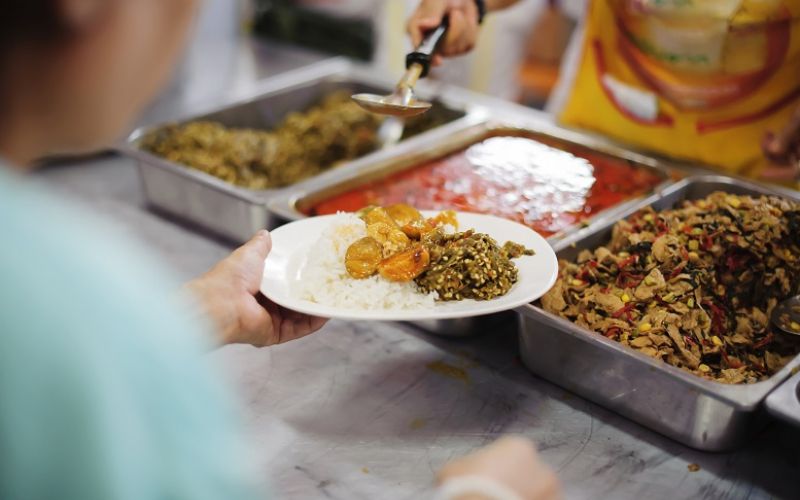 Volunteers serving food for poor people : Food sharing concept