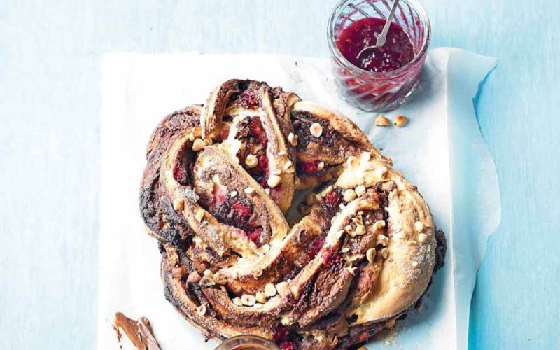 raspberry, chocolate and hazelnut breakfast breadripe and beautifulin seasonadditional information:scattered raspberriespot of jam with spoonjar of nutella with dirty knife