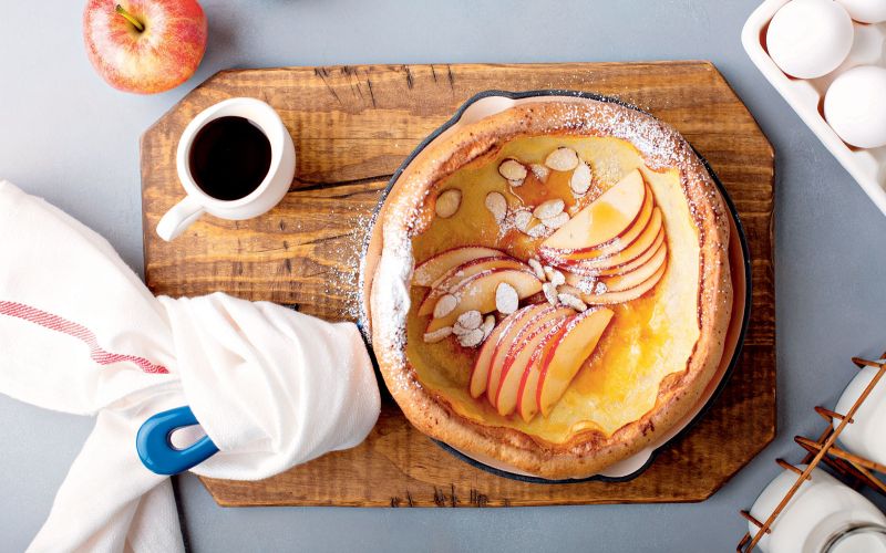 Dutch,Baby,Pancake,With,Apples,,Powdered,Sugar,And,Almonds