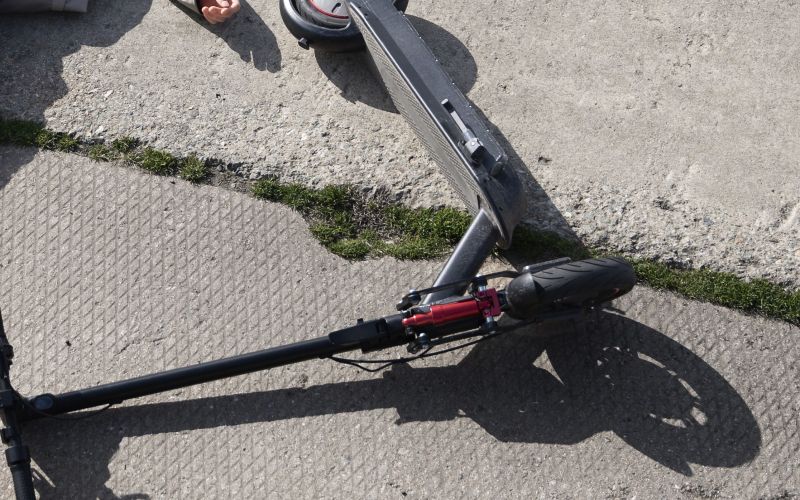 full-shot-man-electric-scooter-laying-ground.jpg
