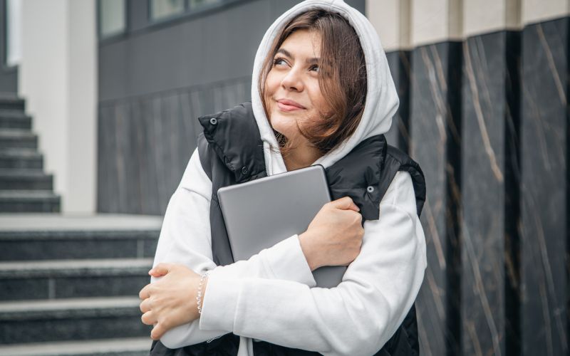 young-female-student-stands-with-digital-tablet-her-hands-outside.jpg