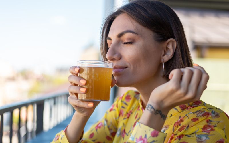 woman-dress-summer-cafe-enjoying-cool-kombucha-glass-beer-sniffing-smell-with-eyes-closed.jpg