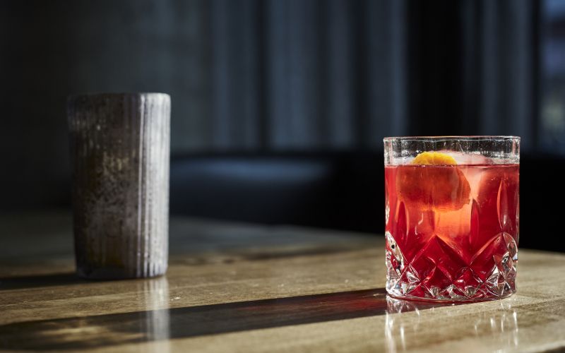 closeup-shot-glass-cocktail-wooden-table.jpg