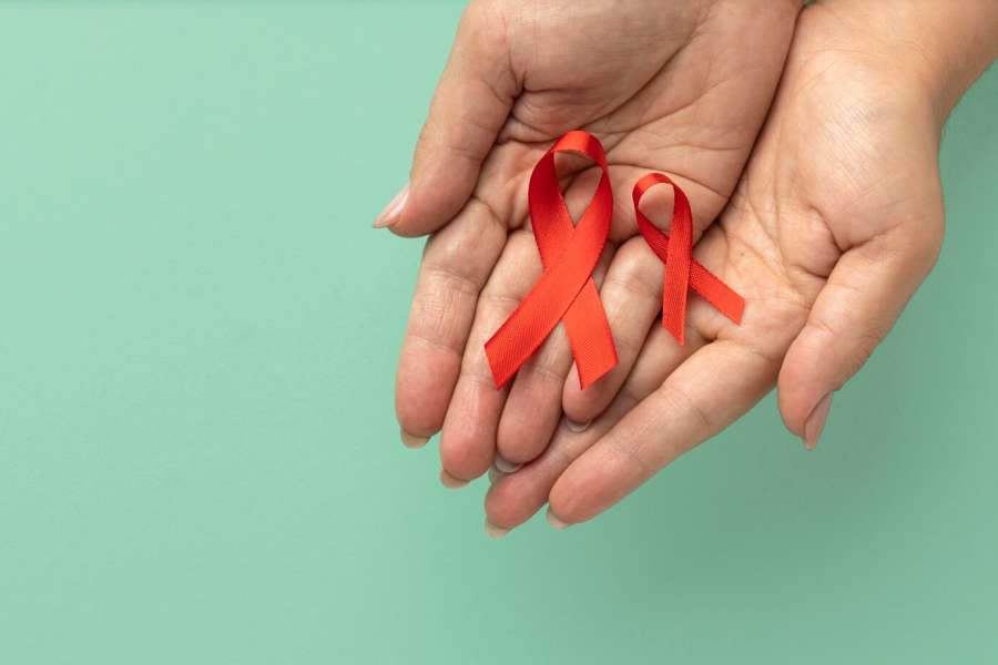 person-holding-world-aids-day-ribbon_23-2149094813